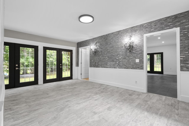 286 Marlborough St, Portland, CT 06480 - empty room with french doors, wood finished floors, and wainscoting