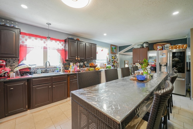 22 Standish Rd, New Milford, CT 06776 - kitchen featuring stainless steel refrigerator with ice dispenser, healthy amount of natural light, dark countertops, recessed lighting, and a textured ceiling