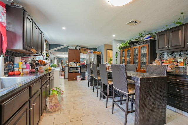22 Standish Rd, New Milford, CT 06776 - kitchen featuring stainless steel microwave, tasteful backsplash, recessed lighting, dark countertops, and light tile patterned floors