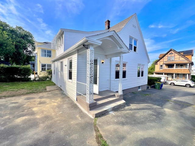 50 Norman St, Waterbury, CT 06708 - view of home's exterior with a chimney