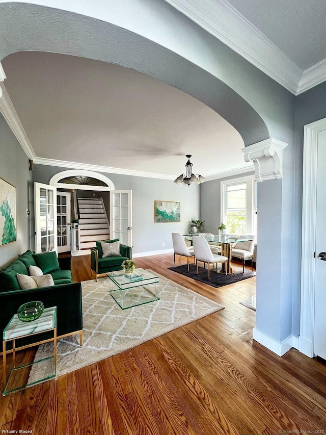50 Norman St, Waterbury, CT 06708 - living area featuring arched walkways, ornamental molding, wood finished floors, a chandelier, and stairs