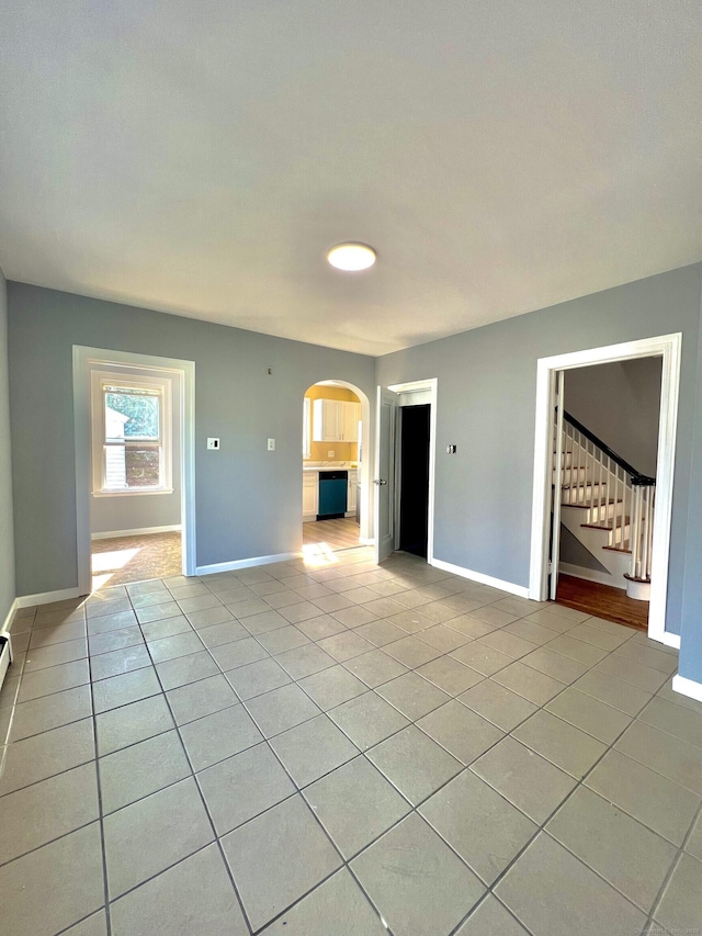 50 Norman St, Waterbury, CT 06708 - unfurnished room featuring arched walkways, light tile patterned floors, and stairs