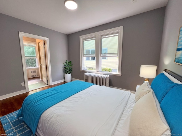 50 Norman St, Waterbury, CT 06708 - bedroom featuring radiator heating unit, wood finished floors, and ensuite bath