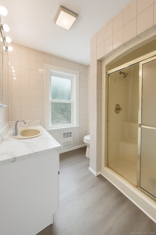 50 Norman St, Waterbury, CT 06708 - full bathroom with tile walls, vanity, wood finished floors, and a shower stall