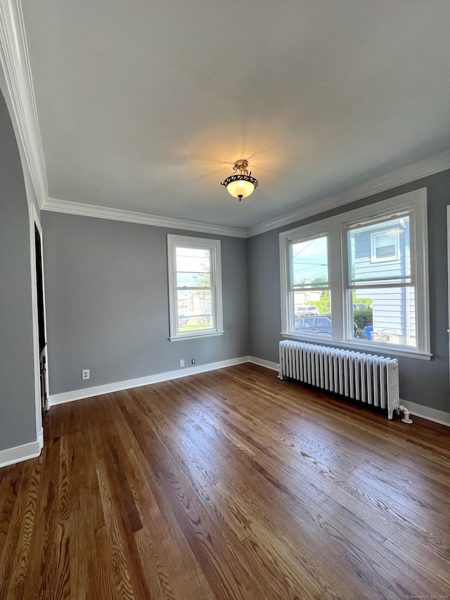 50 Norman St, Waterbury, CT 06708 - unfurnished room with radiator heating unit, ornamental molding, and dark wood-style floors