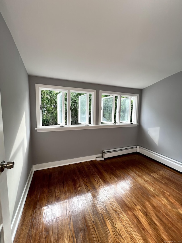 50 Norman St, Waterbury, CT 06708 - spare room featuring plenty of natural light, wood finished floors, and baseboard heating