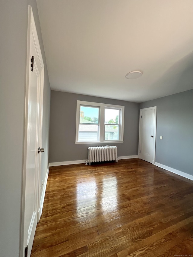 50 Norman St, Waterbury, CT 06708 - unfurnished room featuring radiator and dark wood-style flooring