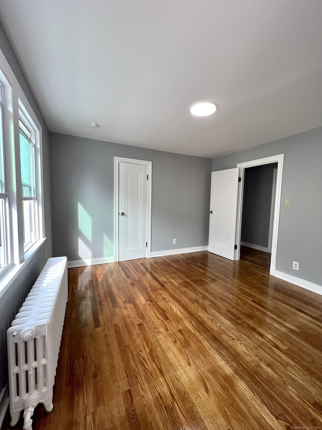 50 Norman St, Waterbury, CT 06708 - empty room with radiator and dark wood-type flooring