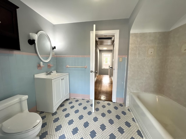 50 Norman St, Waterbury, CT 06708 - full bath with tile walls, tile patterned floors, vanity, and wainscoting