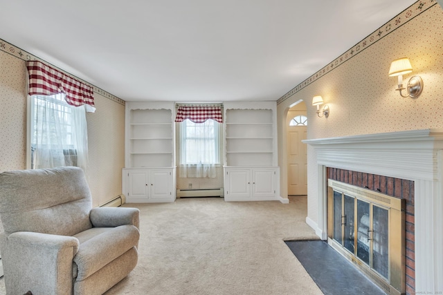 52 Lincoln St, Cromwell, CT 06416 - living area with a baseboard radiator, wallpapered walls, light carpet, a fireplace, and built in features
