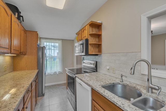 52 Lincoln St, Cromwell, CT 06416 - kitchen with appliances with stainless steel finishes, brown cabinets, decorative backsplash, light tile patterned flooring, and open shelves