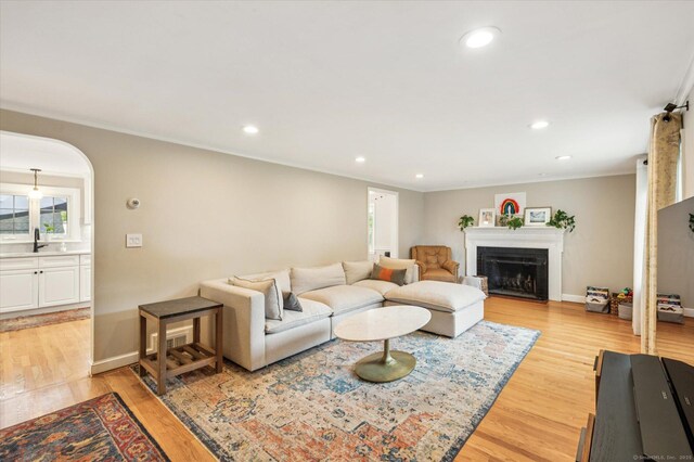 10 Craigmoor Rd, West Hartford, CT 06107 - living area with light wood-style floors, recessed lighting, a fireplace, ornamental molding, and arched walkways