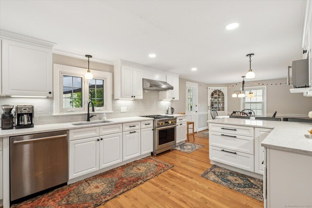 10 Craigmoor Rd, West Hartford, CT 06107 - kitchen with appliances with stainless steel finishes, extractor fan, light wood finished floors, pendant lighting, and recessed lighting