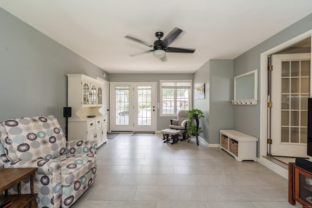 living area featuring ceiling fan and light tile patterned flooring