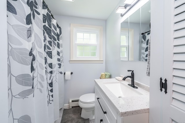 bathroom with baseboard heating, vanity, and tile patterned flooring