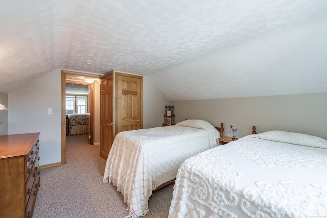 bedroom featuring light colored carpet and lofted ceiling