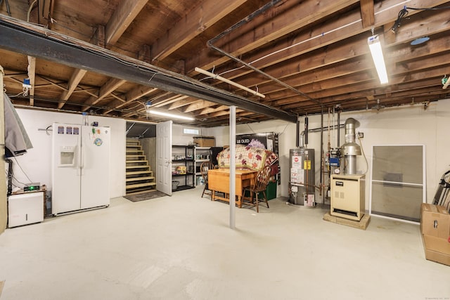 unfinished basement with white fridge with ice dispenser, water heater, and stairs