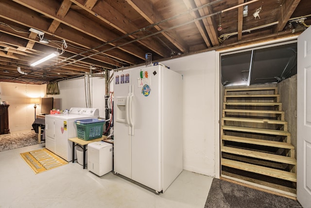 unfinished basement featuring white fridge with ice dispenser and independent washer and dryer
