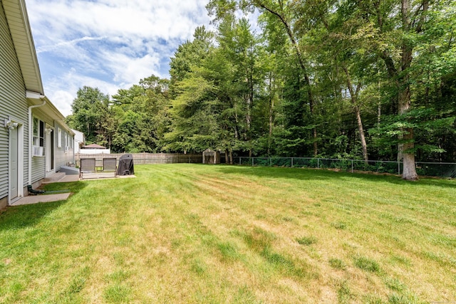 fenced backyard featuring a storage shed and cooling unit