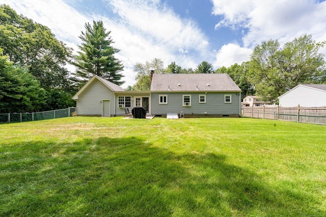 back of house featuring a chimney and a fenced backyard