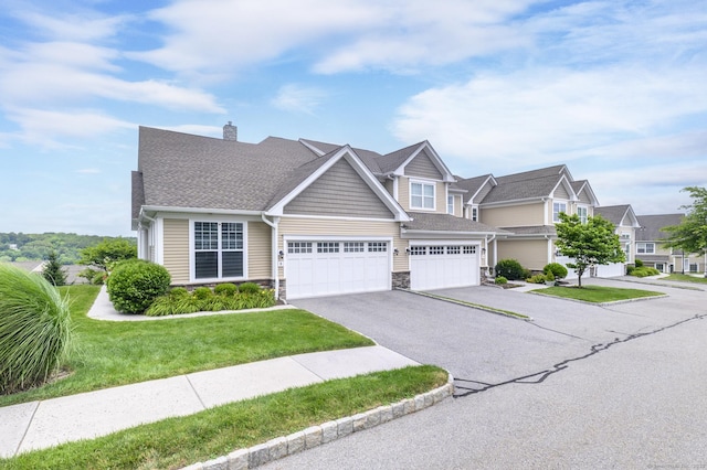 8 Country View Rd Unit 8, Danbury, CT 06810 - view of front of home with driveway, a chimney, stone siding, a front yard, and an attached garage