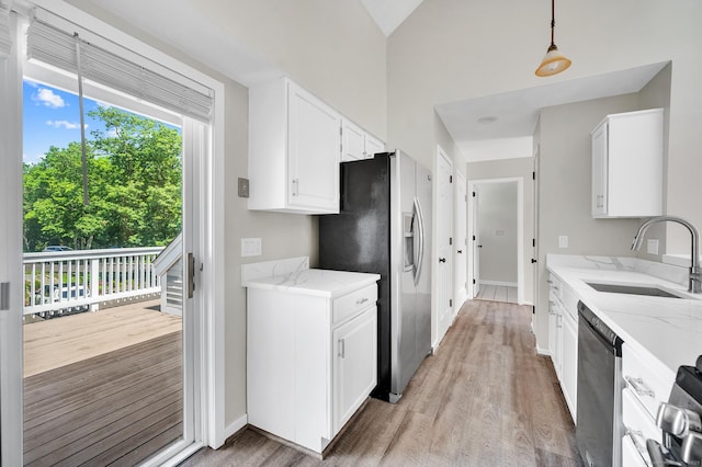 233 Mansfield Grove Rd Unit 306, East Haven, CT 06512 - kitchen with stainless steel appliances, light wood finished floors, light stone countertops, and white cabinets