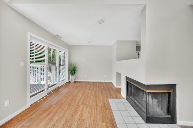 233 Mansfield Grove Rd Unit 306, East Haven, CT 06512 - unfurnished living room with a multi sided fireplace and wood finished floors