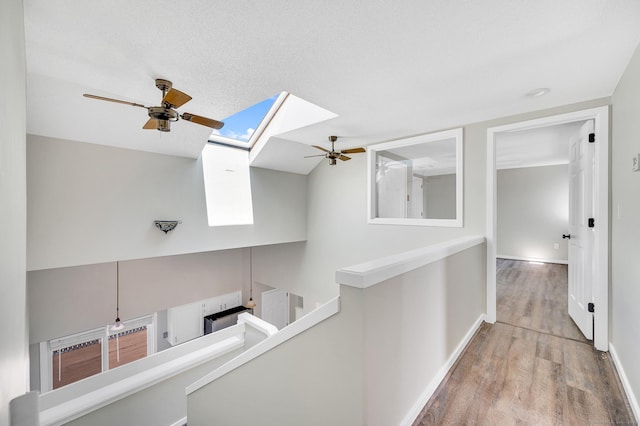 233 Mansfield Grove Rd Unit 306, East Haven, CT 06512 - hallway featuring a skylight and wood finished floors