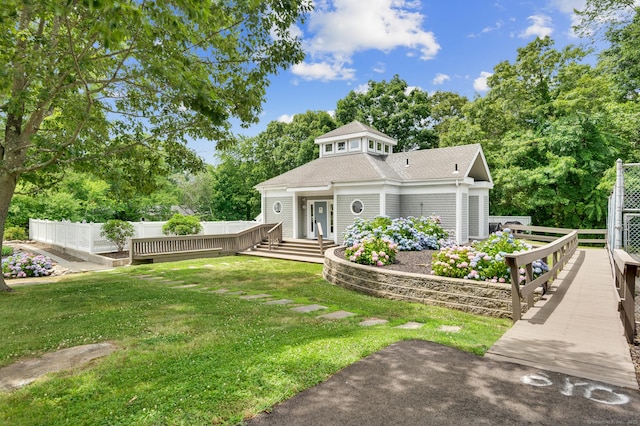 233 Mansfield Grove Rd Unit 306, East Haven, CT 06512 - view of front of house featuring roof with shingles, a garden, and view of wooded area