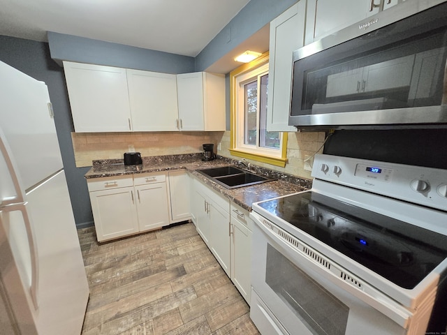 1190 Meriden Rd, Waterbury, CT 06705 - kitchen featuring white appliances, white cabinetry, tasteful backsplash, and dark countertops