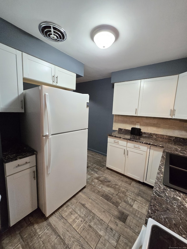 1190 Meriden Rd, Waterbury, CT 06705 - kitchen featuring freestanding refrigerator, dark wood finished floors, white cabinets, and dark stone countertops
