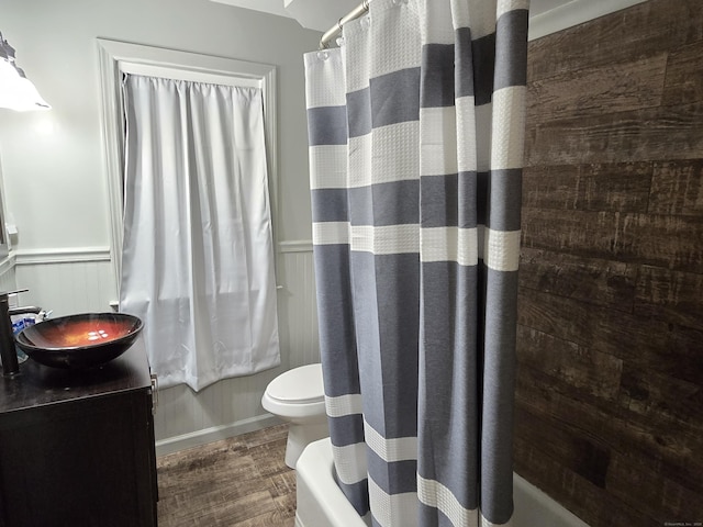 1190 Meriden Rd, Waterbury, CT 06705 - full bathroom featuring shower / bath combo with shower curtain, vanity, wood finished floors, and a wainscoted wall