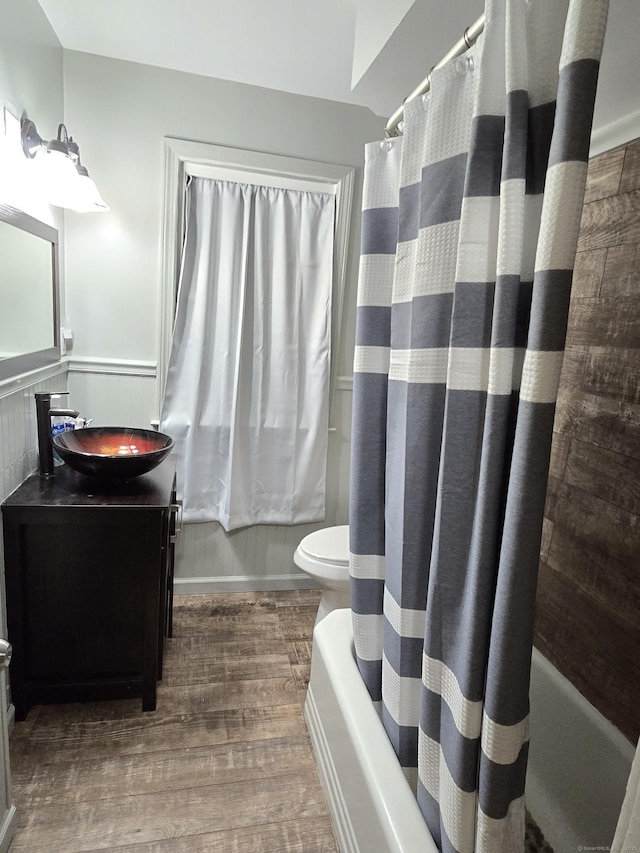 1190 Meriden Rd, Waterbury, CT 06705 - full bath featuring shower / bath combo with shower curtain, wood finished floors, vanity, and wainscoting