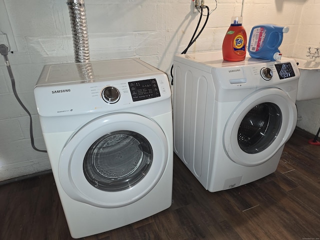 1190 Meriden Rd, Waterbury, CT 06705 - laundry room with independent washer and dryer, wood finished floors, and concrete block wall