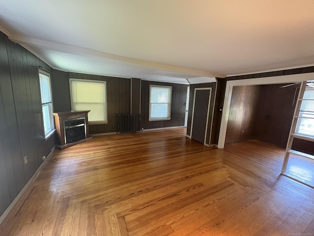 2 Sherwood St, Branford, CT 06405 - unfurnished living room featuring radiator, a fireplace, and wooden walls