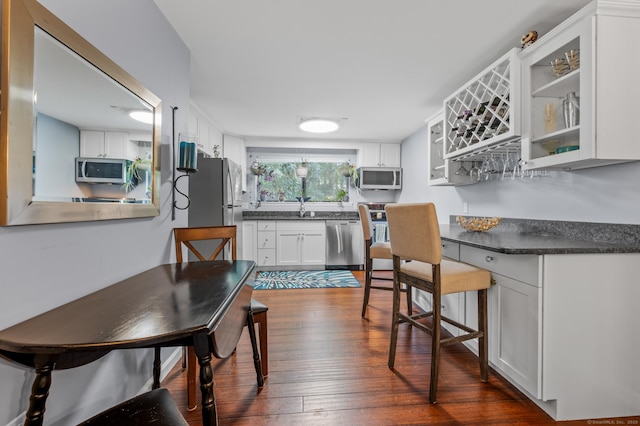 14 Conestoga Way Unit 14, Glastonbury, CT 06033 - dining room featuring dark wood-style flooring and a bar