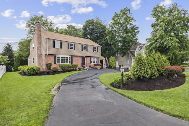 1182 N Main St, West Hartford, CT 06117 - colonial house with brick siding, a chimney, and asphalt driveway