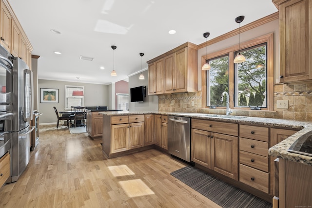 1182 N Main St, West Hartford, CT 06117 - kitchen with appliances with stainless steel finishes, a peninsula, crown molding, light wood-style floors, and light stone countertops
