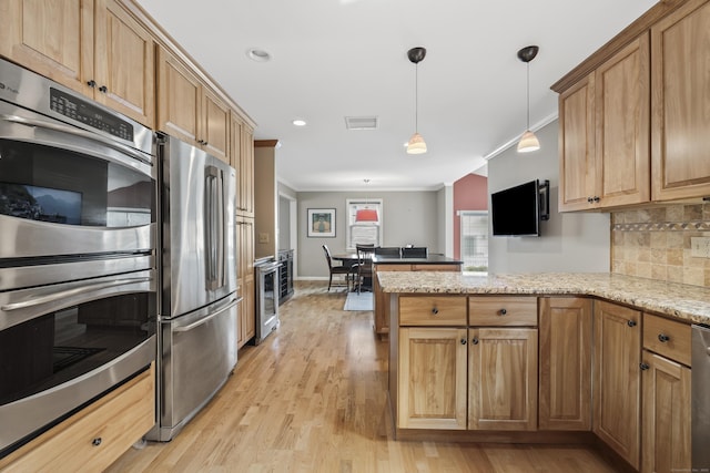 1182 N Main St, West Hartford, CT 06117 - kitchen with stainless steel appliances, a peninsula, ornamental molding, wine cooler, and decorative light fixtures