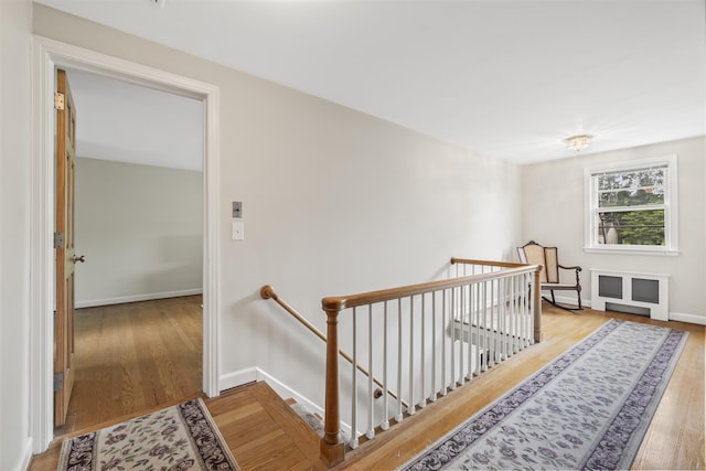 1182 N Main St, West Hartford, CT 06117 - hallway with an upstairs landing, wood finished floors, and radiator heating unit