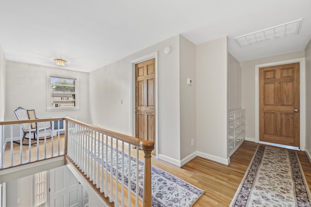 1182 N Main St, West Hartford, CT 06117 - corridor featuring an upstairs landing and wood finished floors