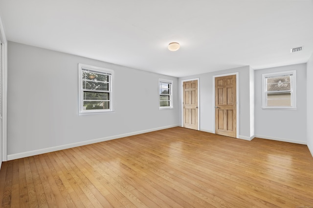 1182 N Main St, West Hartford, CT 06117 - unfurnished bedroom with light wood finished floors and multiple closets