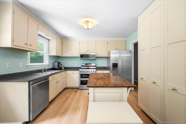 46 Union Dr, Ashford, CT 06278 - kitchen with appliances with stainless steel finishes, a kitchen island, cream cabinets, and light wood-type flooring