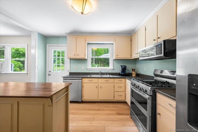 46 Union Dr, Ashford, CT 06278 - kitchen featuring appliances with stainless steel finishes, dark countertops, light wood-style flooring, and plenty of natural light