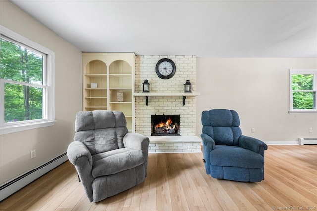 46 Union Dr, Ashford, CT 06278 - living area with baseboard heating, wood finished floors, and a brick fireplace