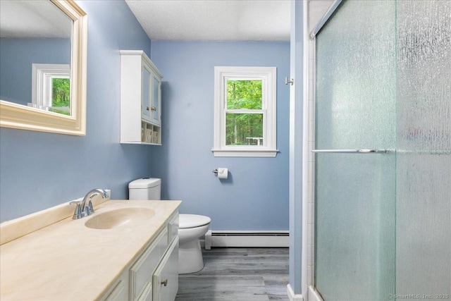 46 Union Dr, Ashford, CT 06278 - full bathroom with baseboard heating, wood finished floors, vanity, and a shower stall