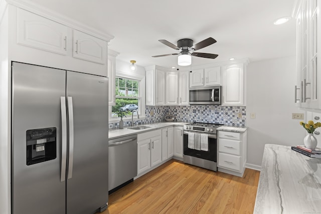 119 Debra Ln, Bristol, CT 06010 - kitchen with appliances with stainless steel finishes, white cabinetry, backsplash, a ceiling fan, and light stone countertops