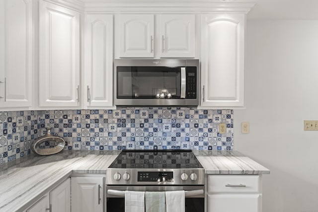 119 Debra Ln, Bristol, CT 06010 - kitchen featuring appliances with stainless steel finishes, tasteful backsplash, and white cabinetry