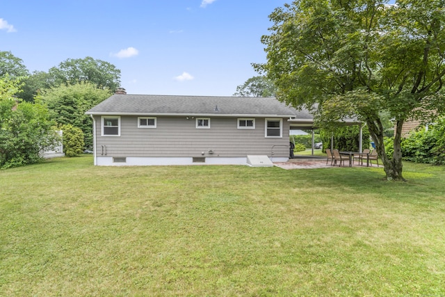 119 Debra Ln, Bristol, CT 06010 - rear view of house with a patio, a yard, a chimney, and a carport