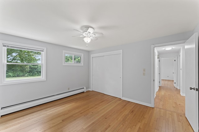 119 Debra Ln, Bristol, CT 06010 - unfurnished bedroom with a baseboard radiator, light wood-style flooring, a closet, and a ceiling fan